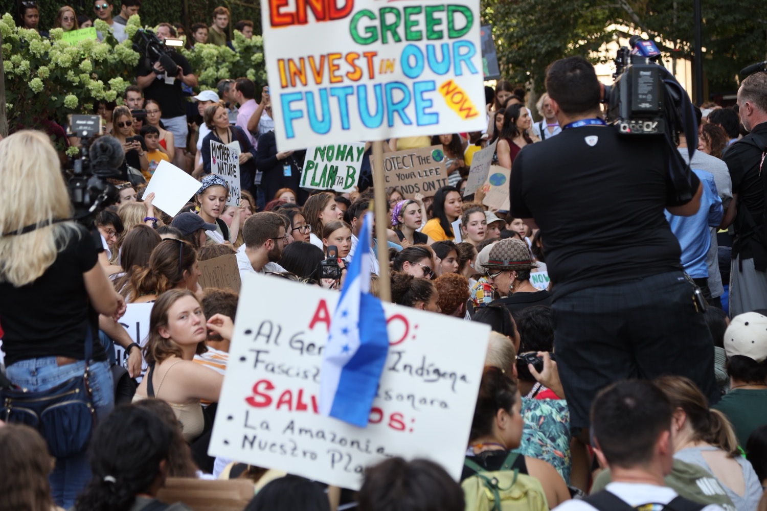 DJ facing a crowd at his deck. Photo with a purple hue